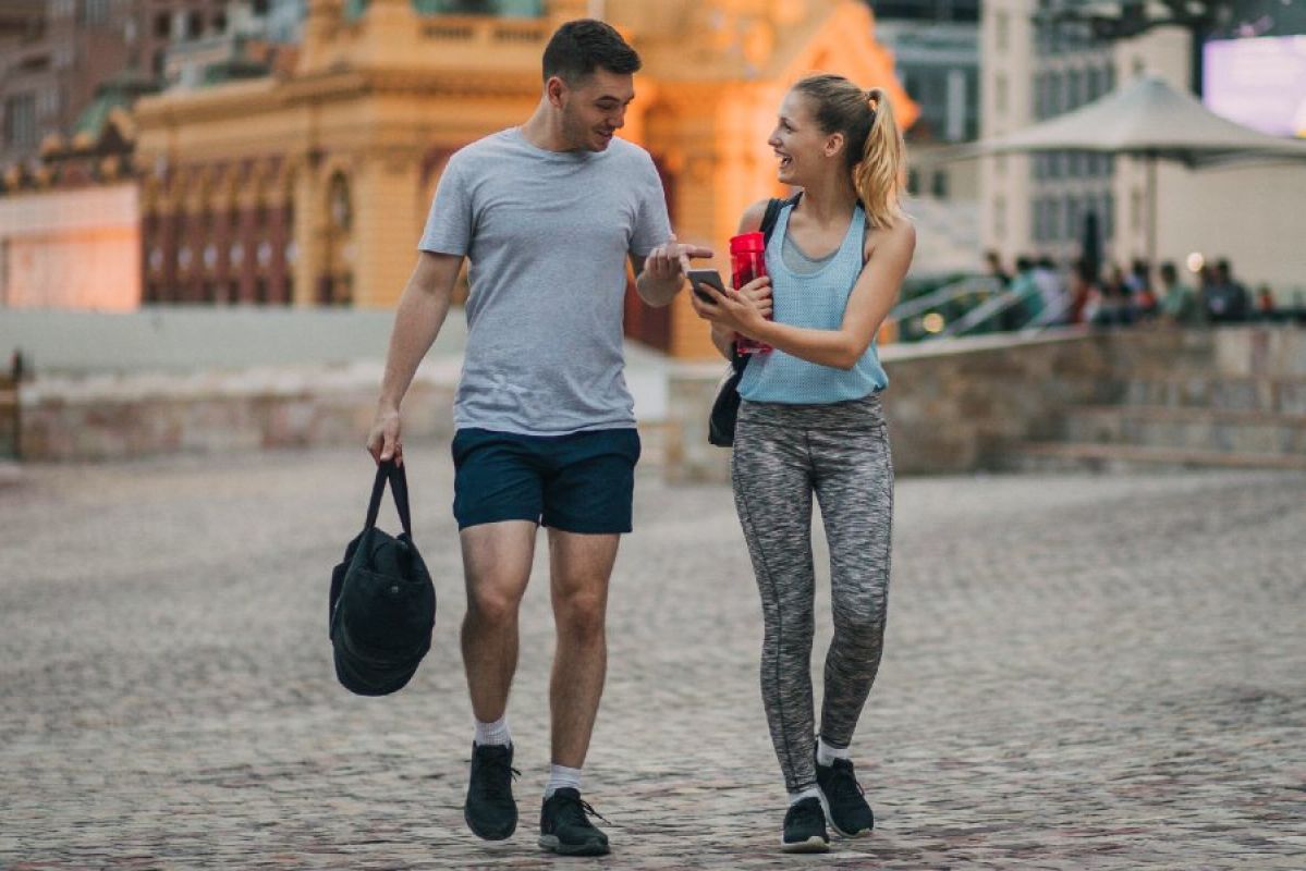 man and woman looking at smartphone in Melbourne