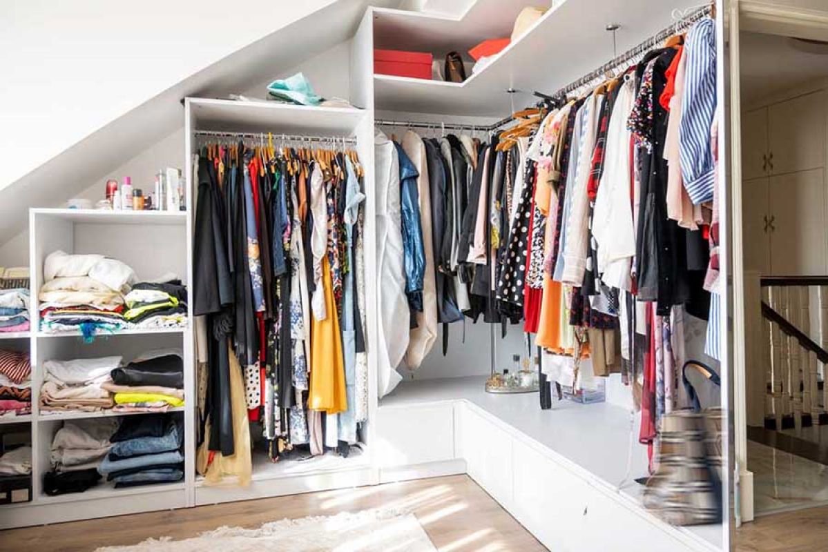 Woman folding clothes in a wardrobe