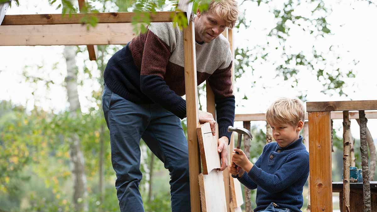 Father and son building a treehouse together