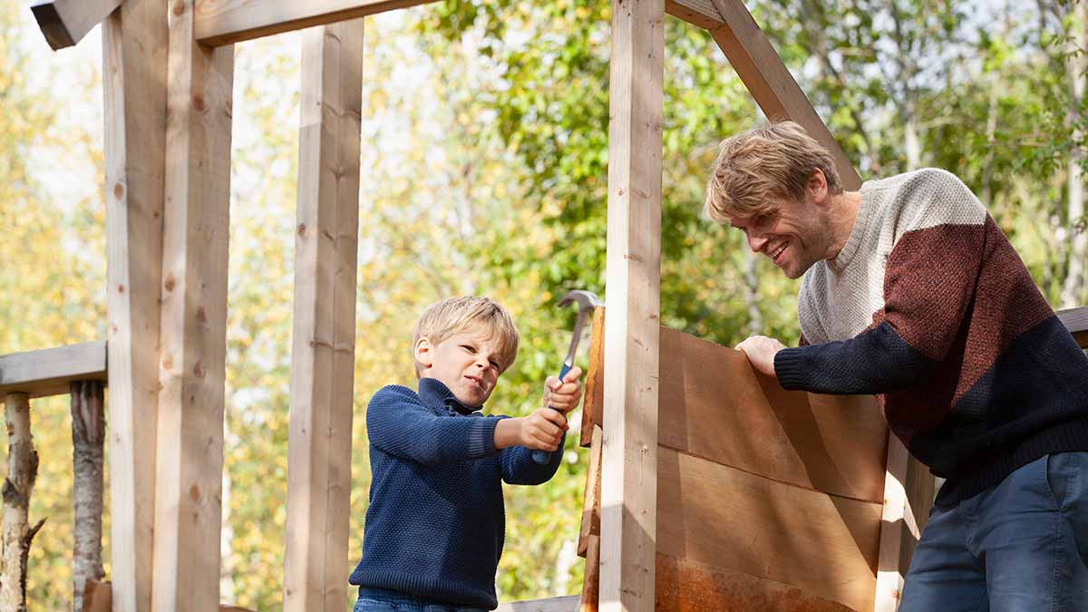 Father and son building a treehouse together