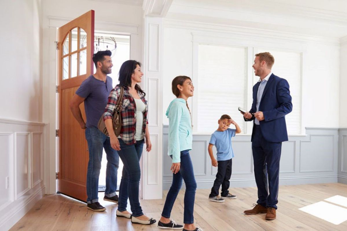 real estate agent showing family a house