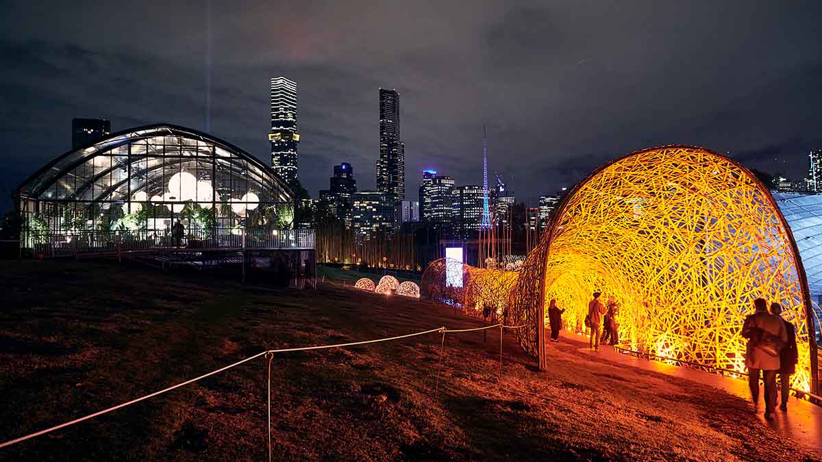 Nighttime photograph of a straw-like webbed sculpture