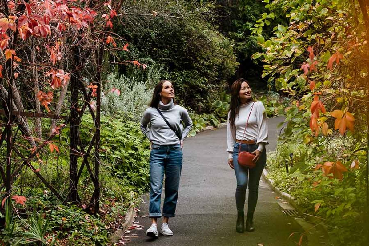 Two girls walking through Royal Botanic Gardens in Melbourne