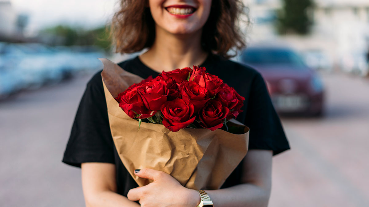 woman holding bunch of roses