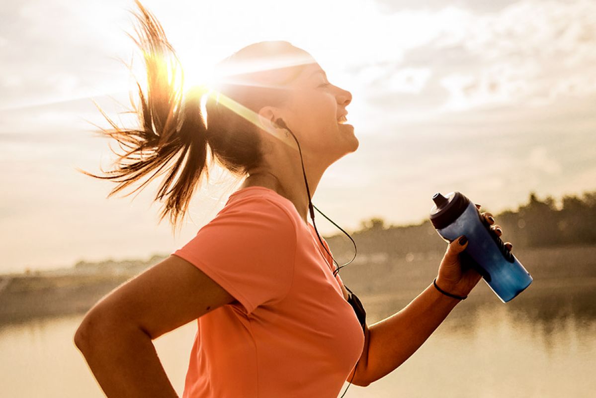 Woman running with drink bottle