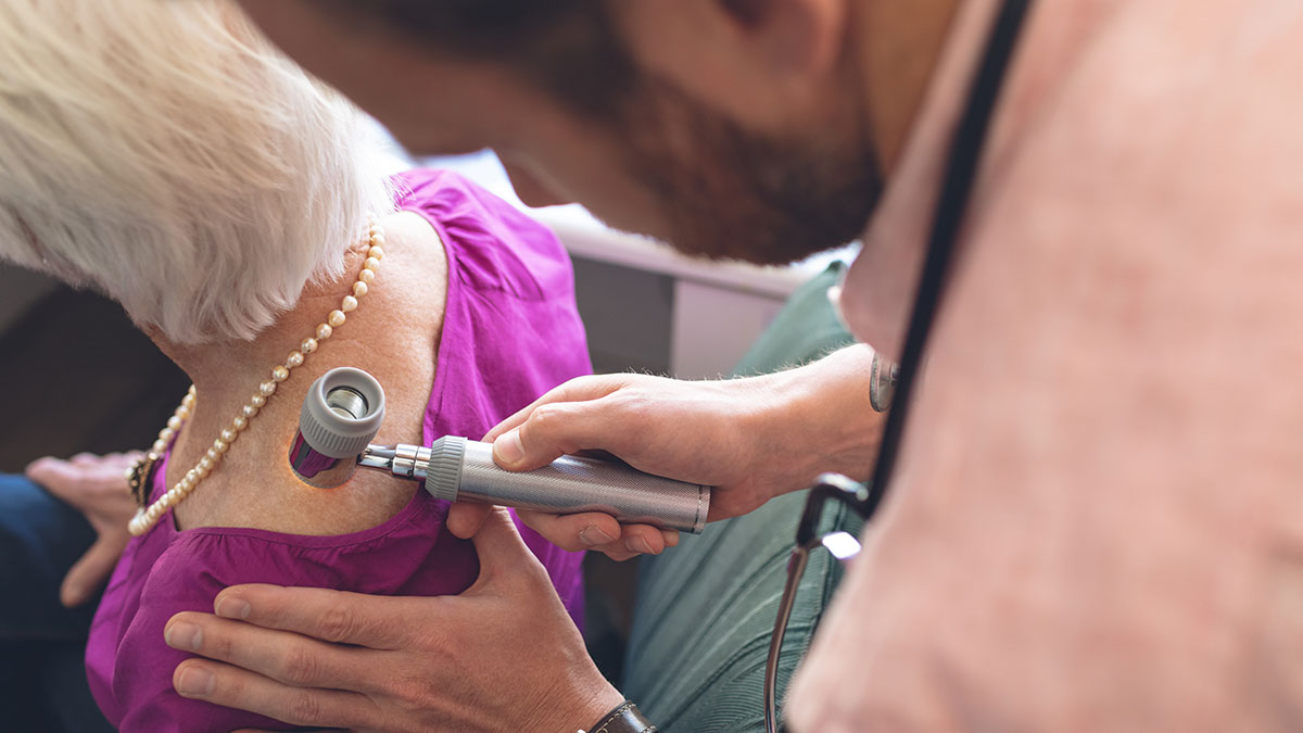 person having skin check by a doctor