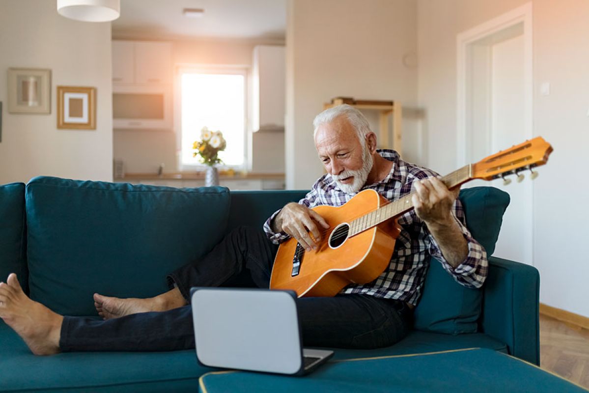 Senior man learning guitar