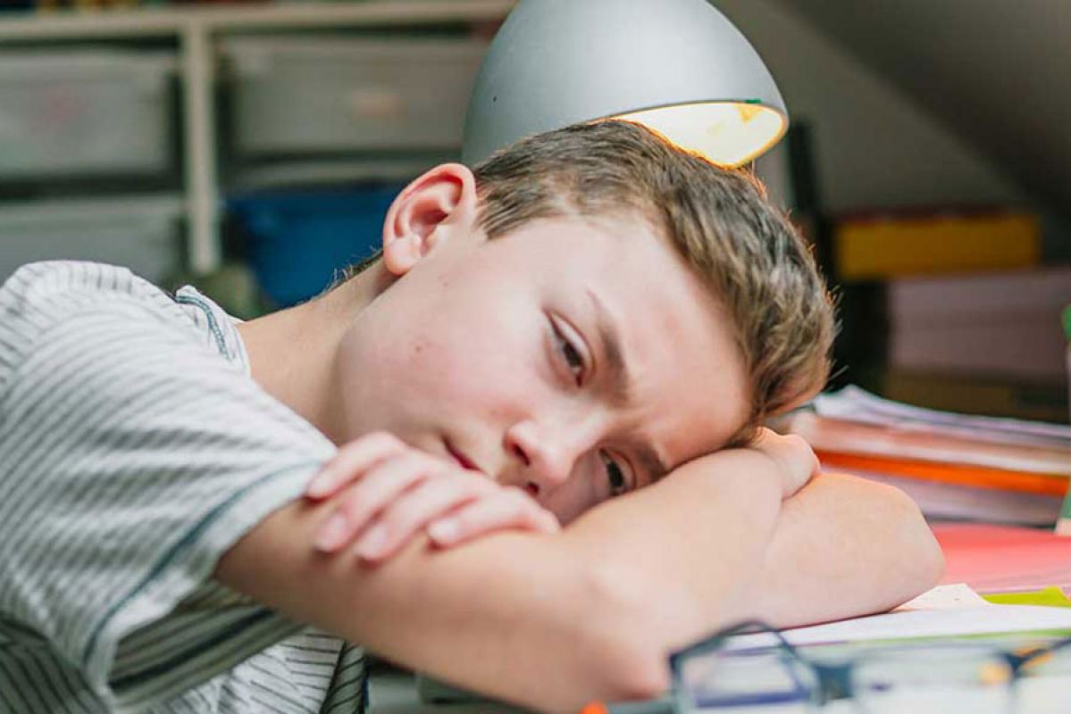 teeanger asleep at his desk