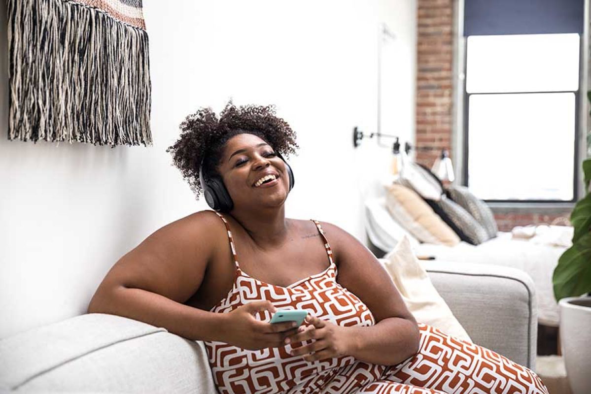 woman listening to podcast with headphones on