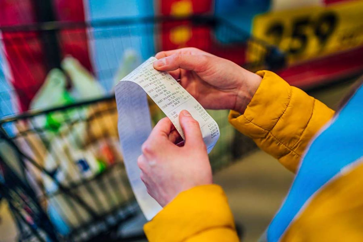 Person looking at grocery receipt