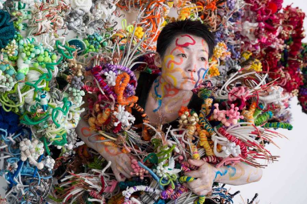 Artist Hiromi Tango entwined in her colourful soft sculpture creations