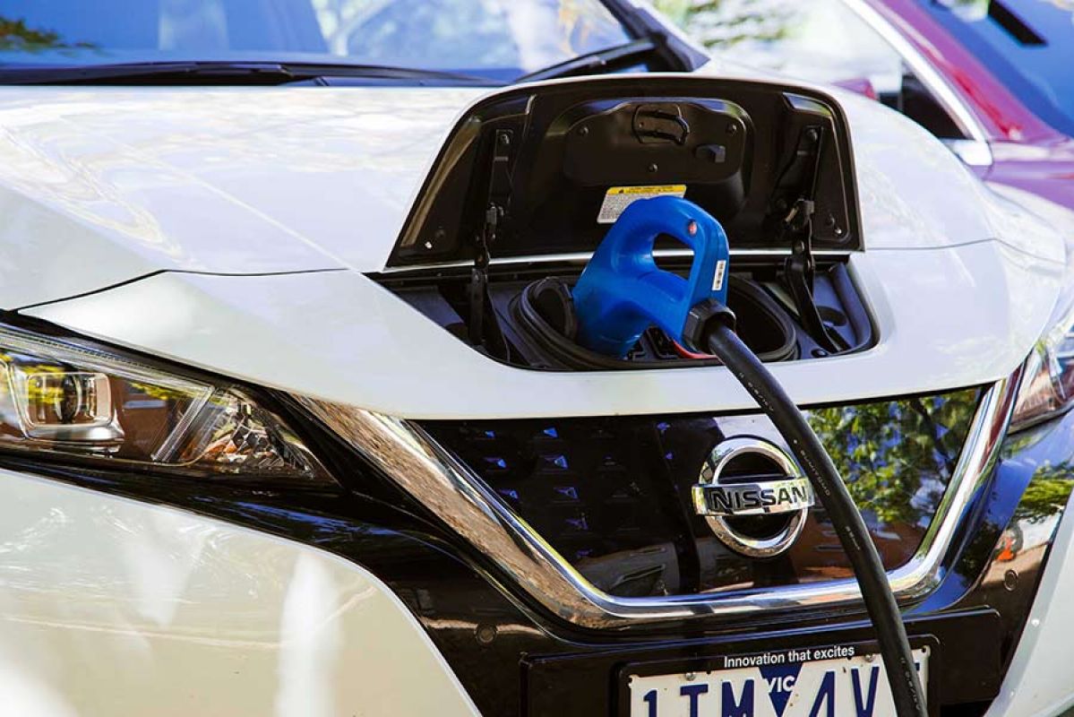 A white Nissan Leaf EV being charged using bi-directional charging