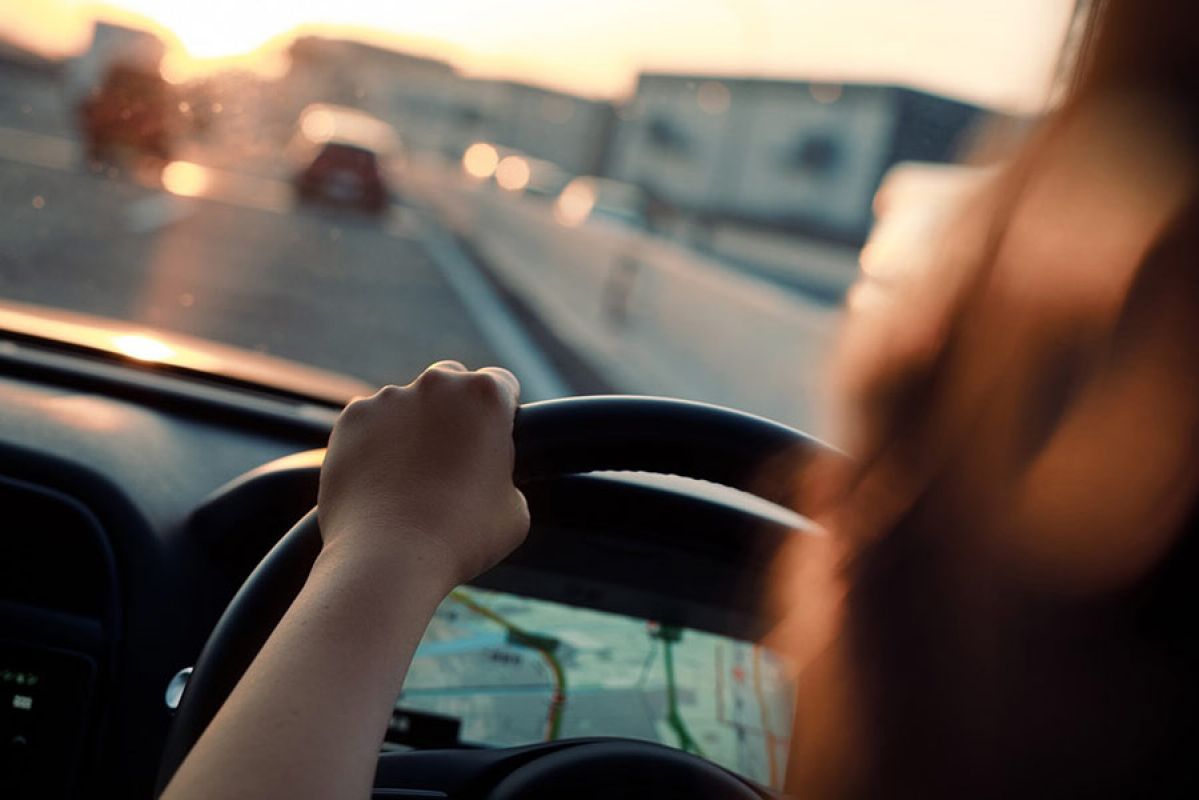 Person driving car with reduced focus.