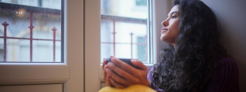 Woman looking out window