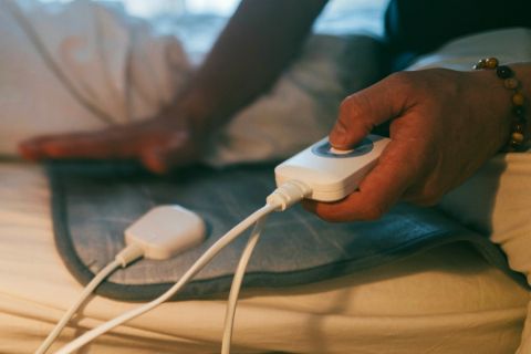 A person using an electric blanket controller