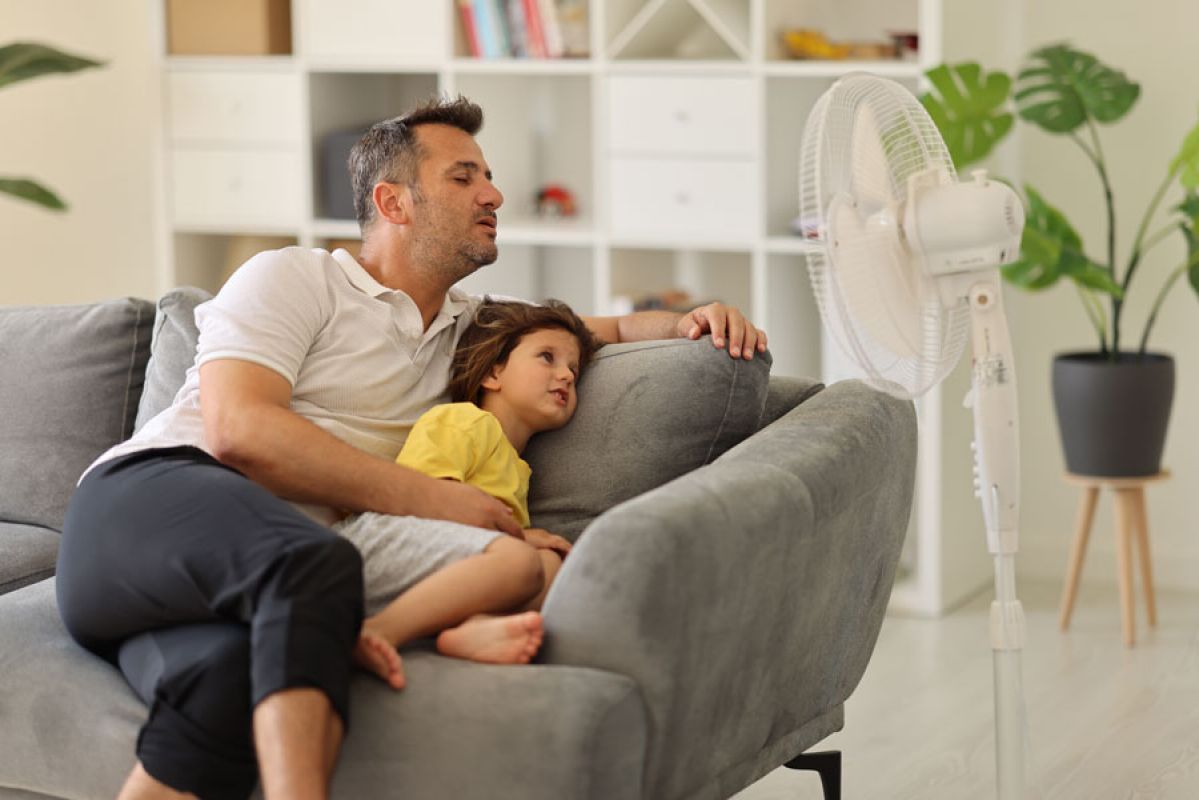 family cooling in front of fan