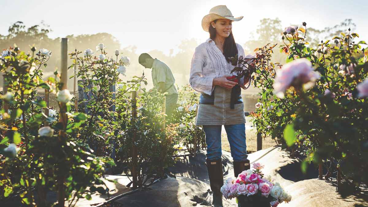 Woman preparing flowers outside