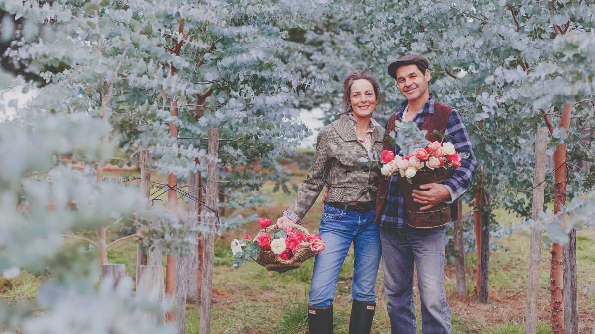 Couple outside holding flowers