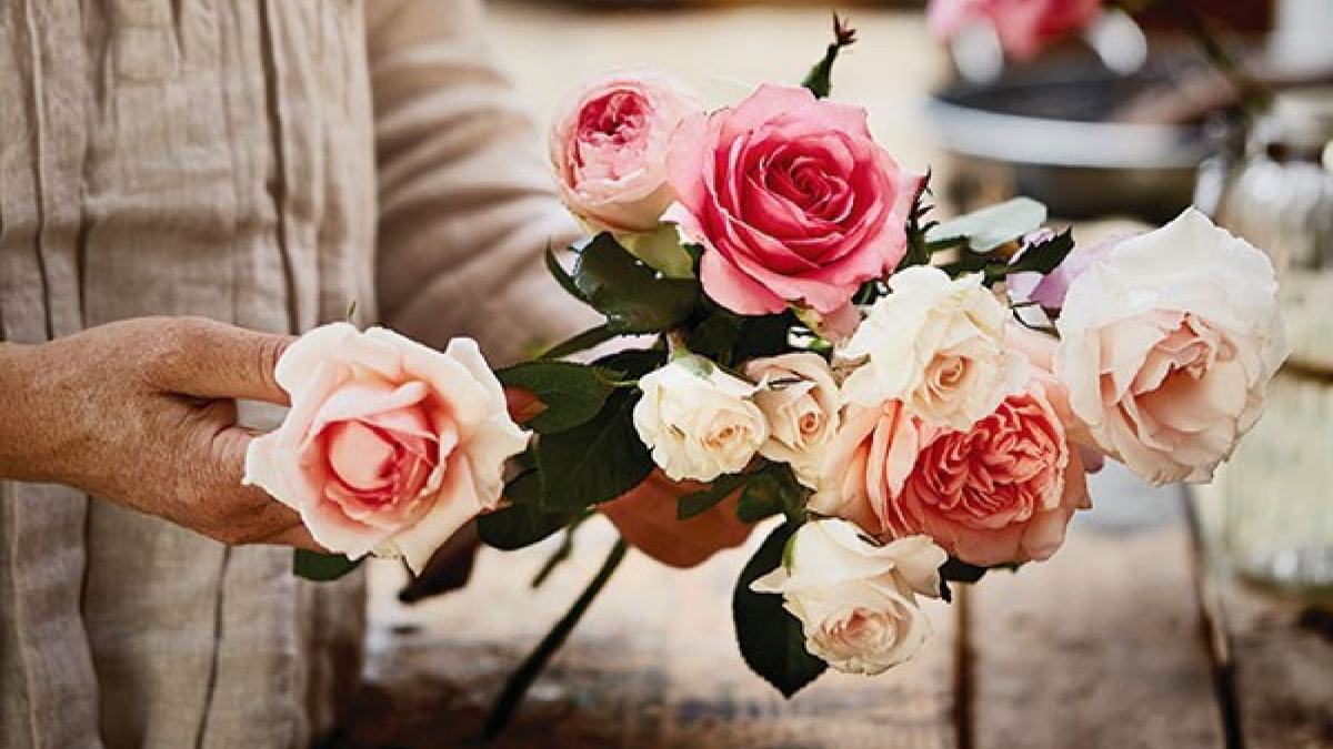 Woman putting together a bunch of roses