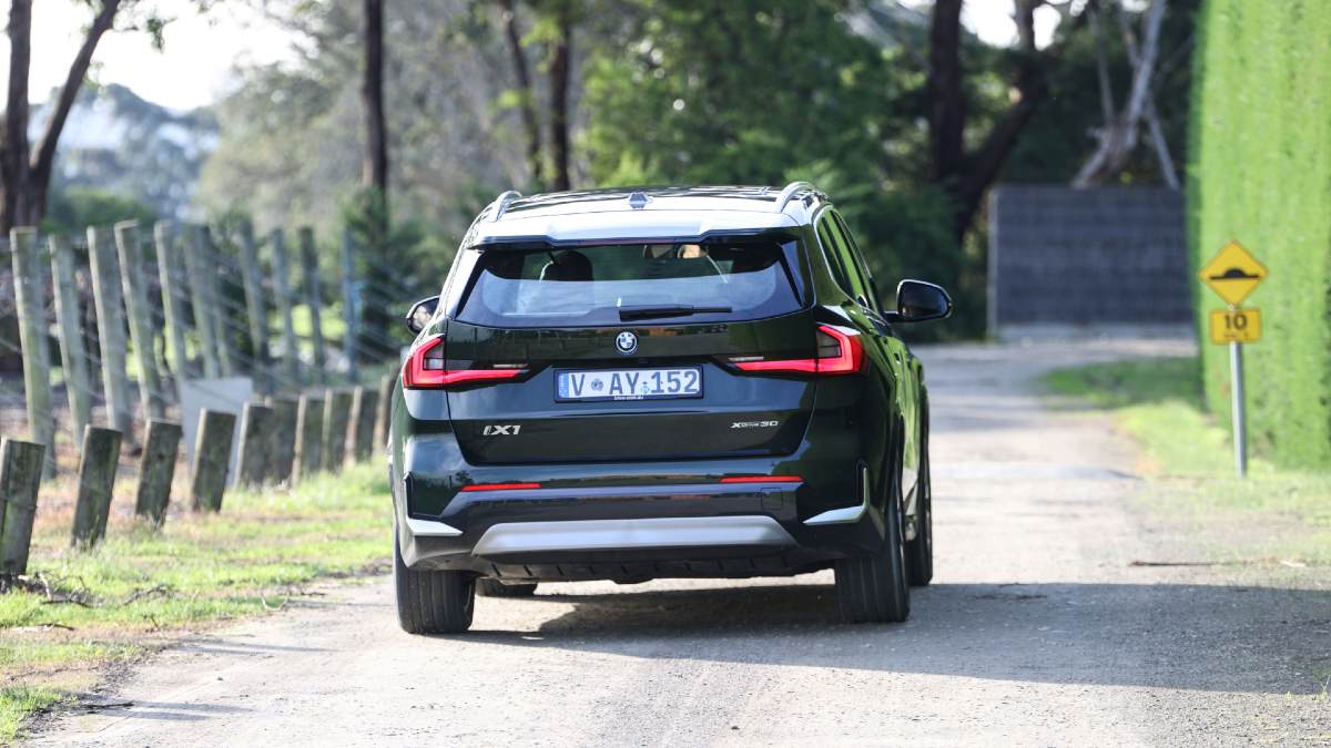 BMW iX1 rear shot driving on country road