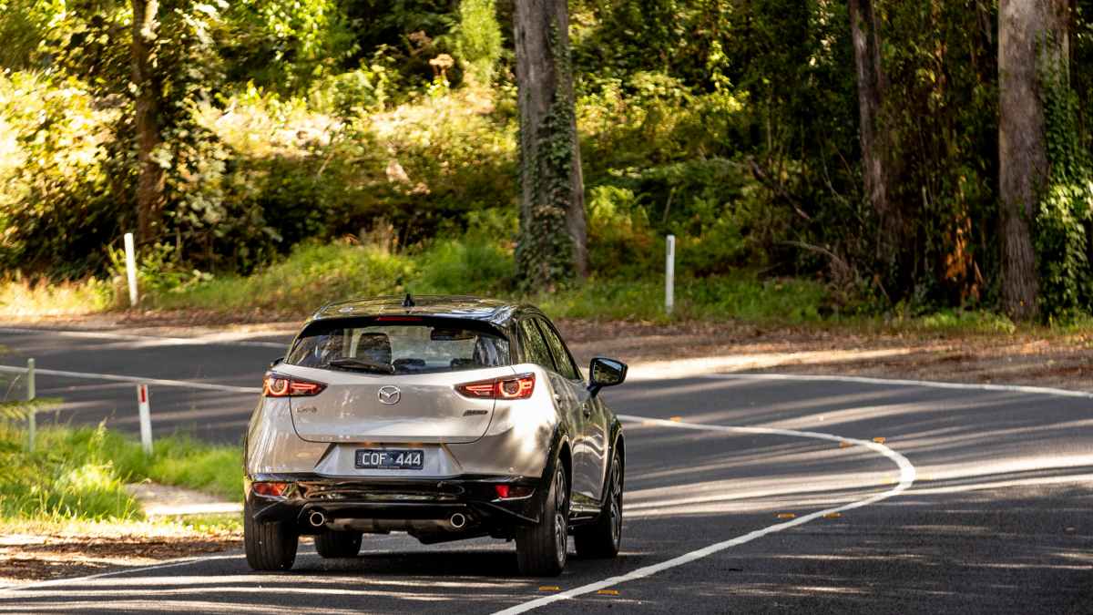 2024 Mazda CX-3 Touring SP rear shot of driving along road