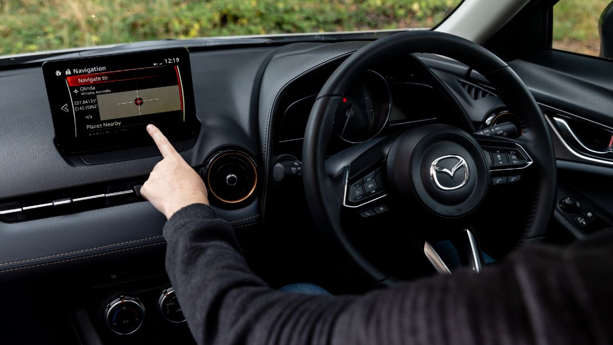 2024 Mazda CX-3 Touring SP with driver about to use touchscreen