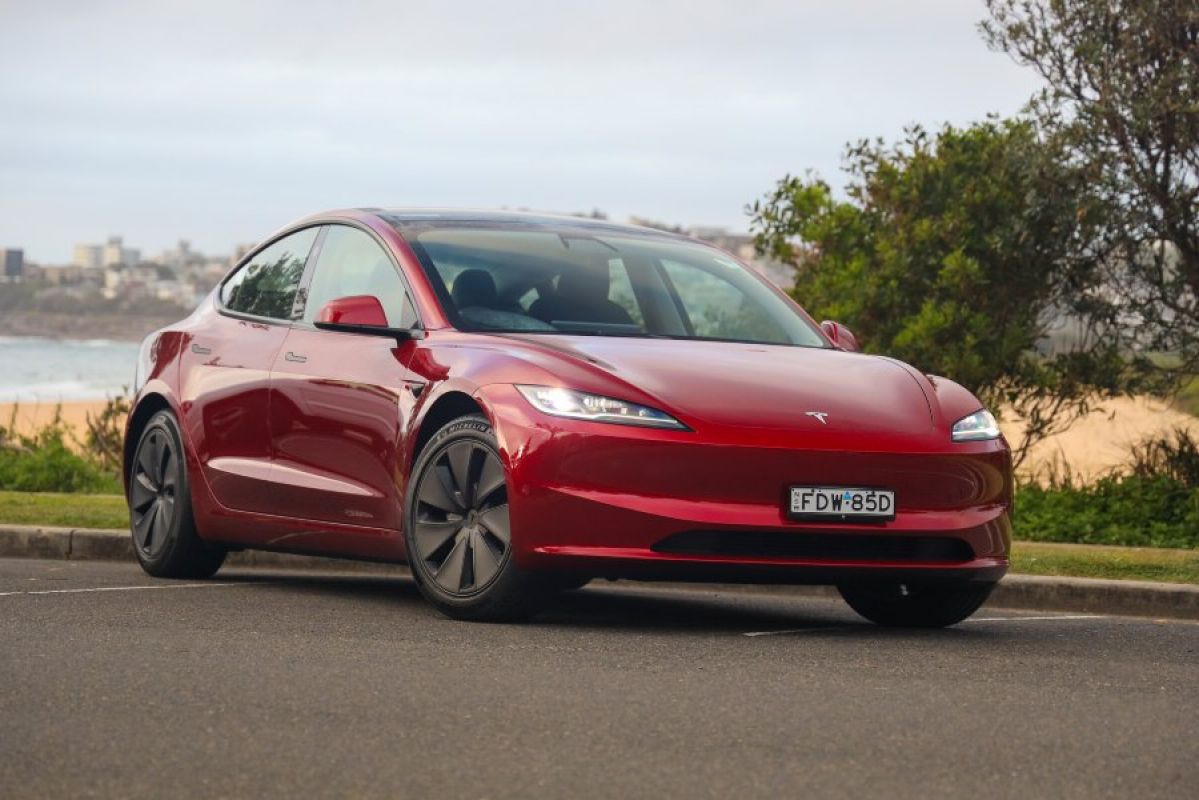 red Tesla Model 3 parked outside