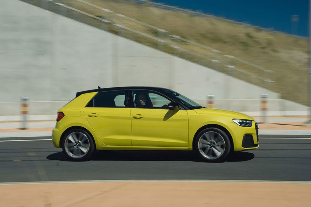 side of lime green Audi A1 driving 