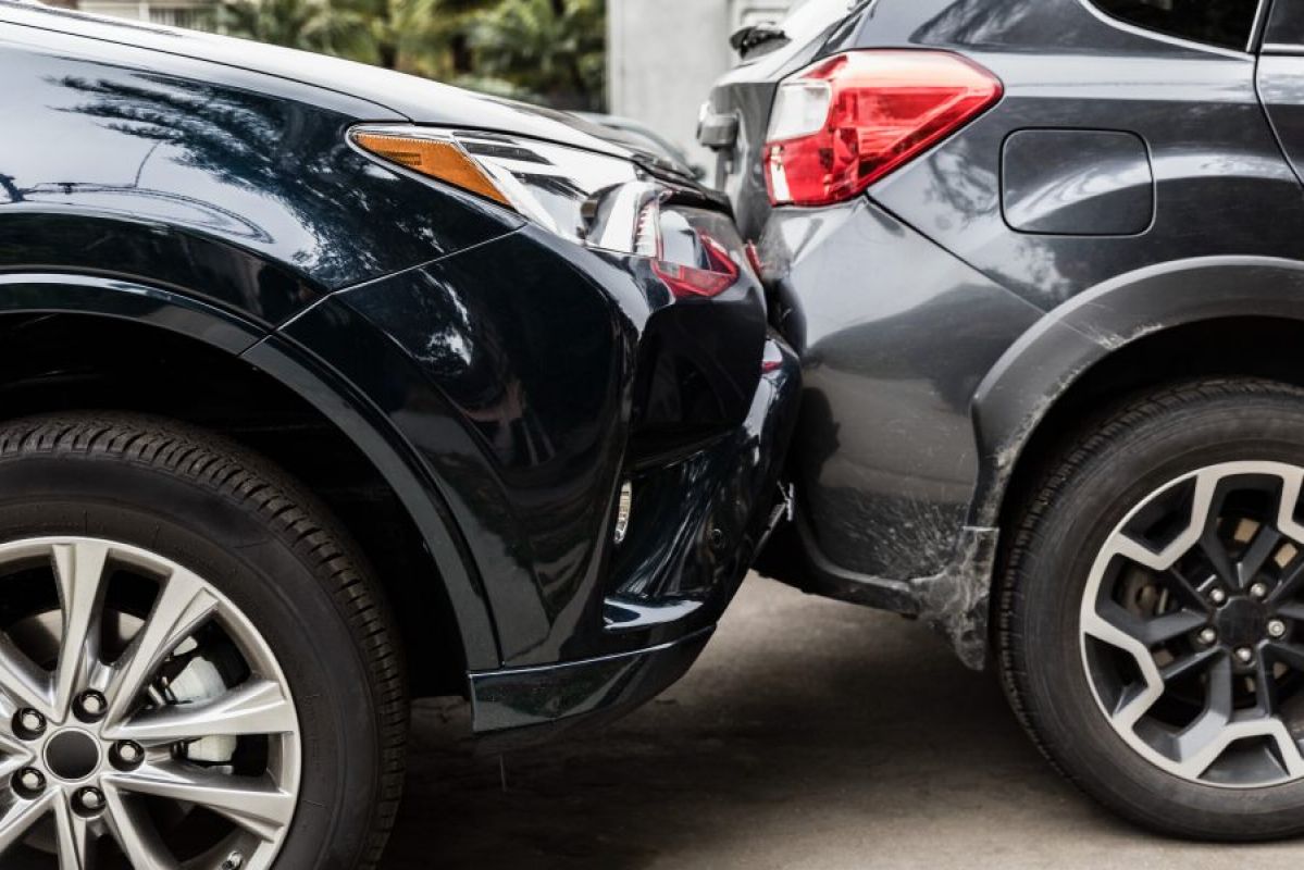 black car rear-ending a gray car