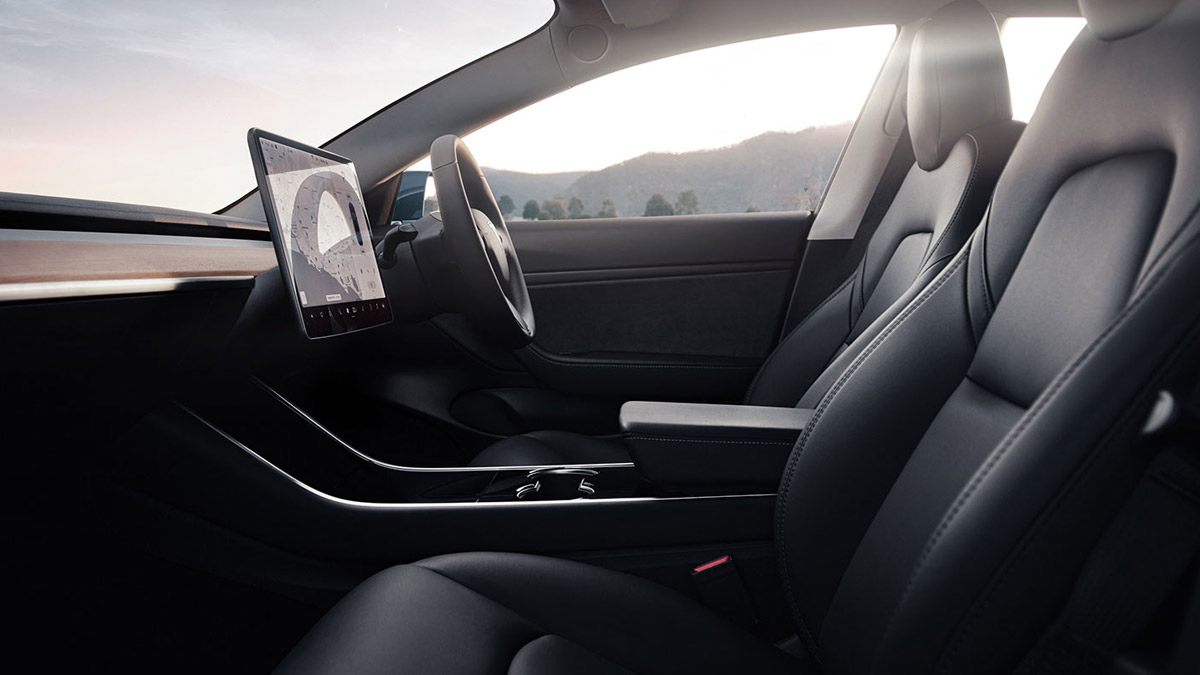 Interior side view of passenger and driver seats in the Tesla Model 3