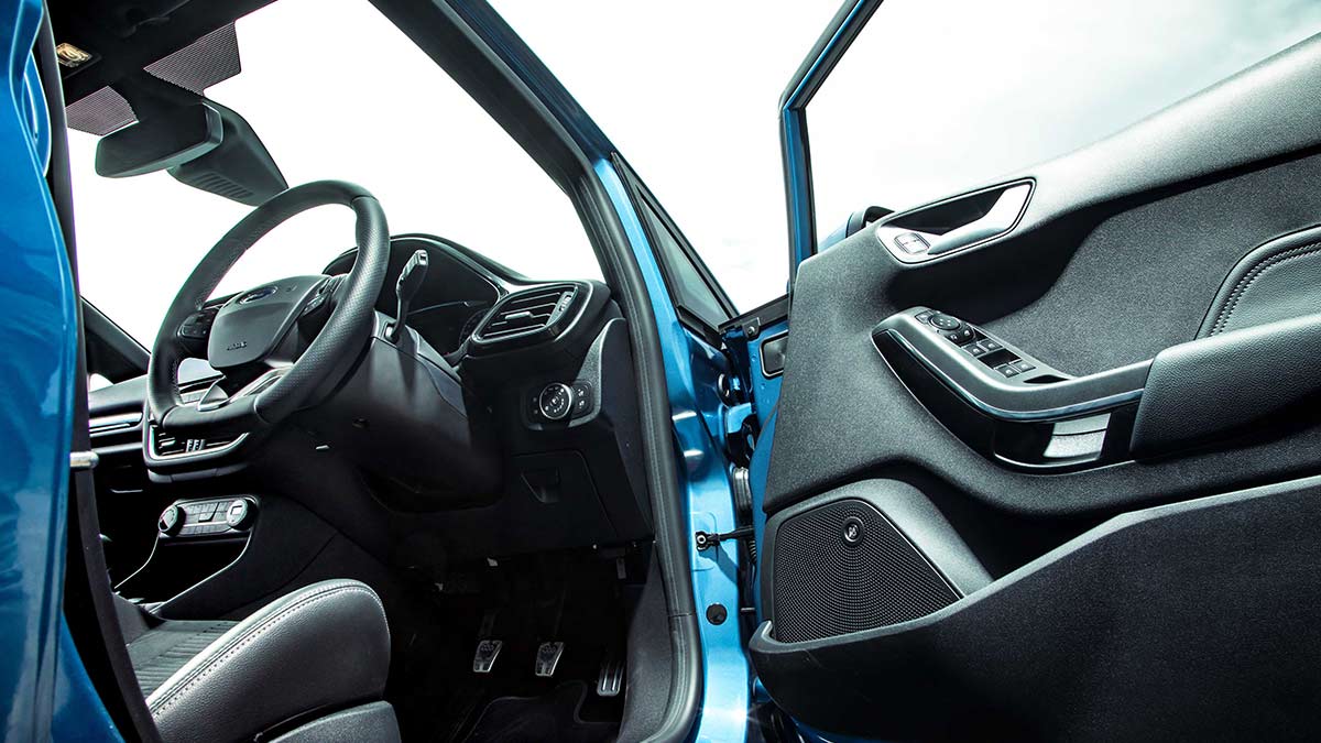 Open driver's side door and steering wheel inside the Ford Fiesta ST 2020