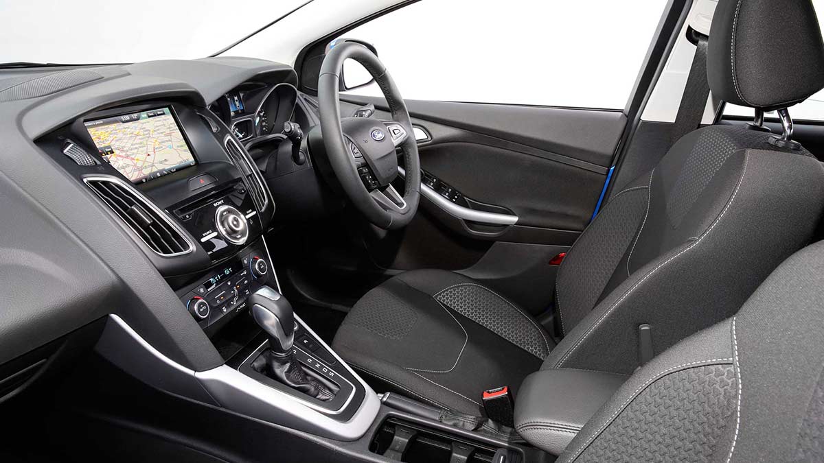 Grey interior of the Ford Focus LZ showing the front seats, centre console and steering wheel