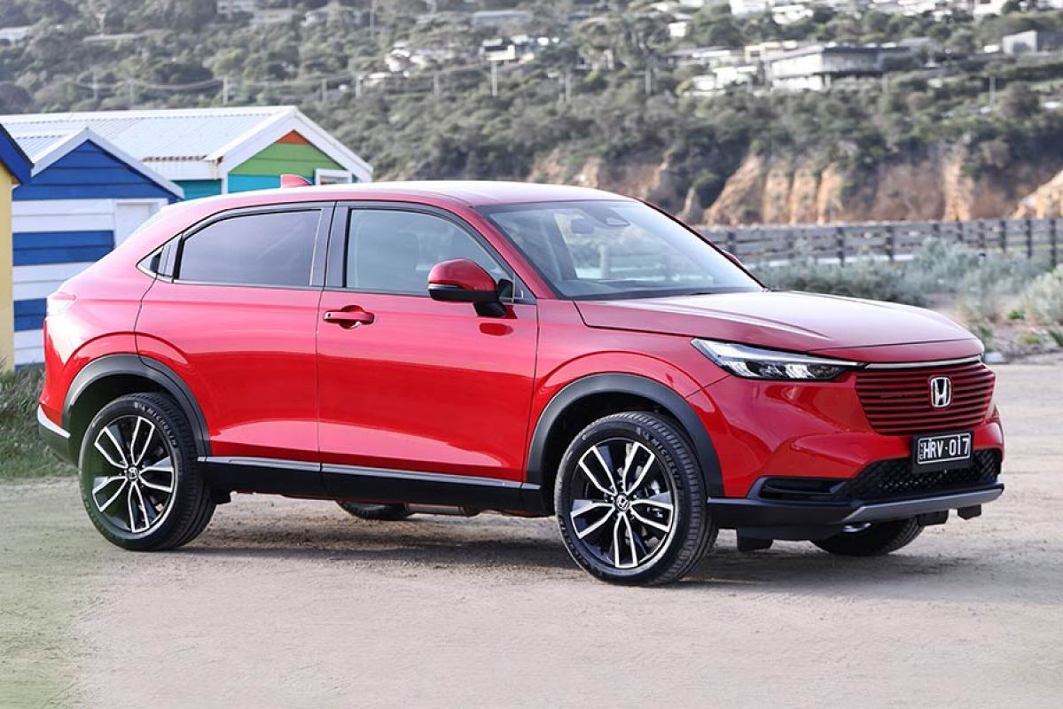 A red Honda HR-V parked near a beach.