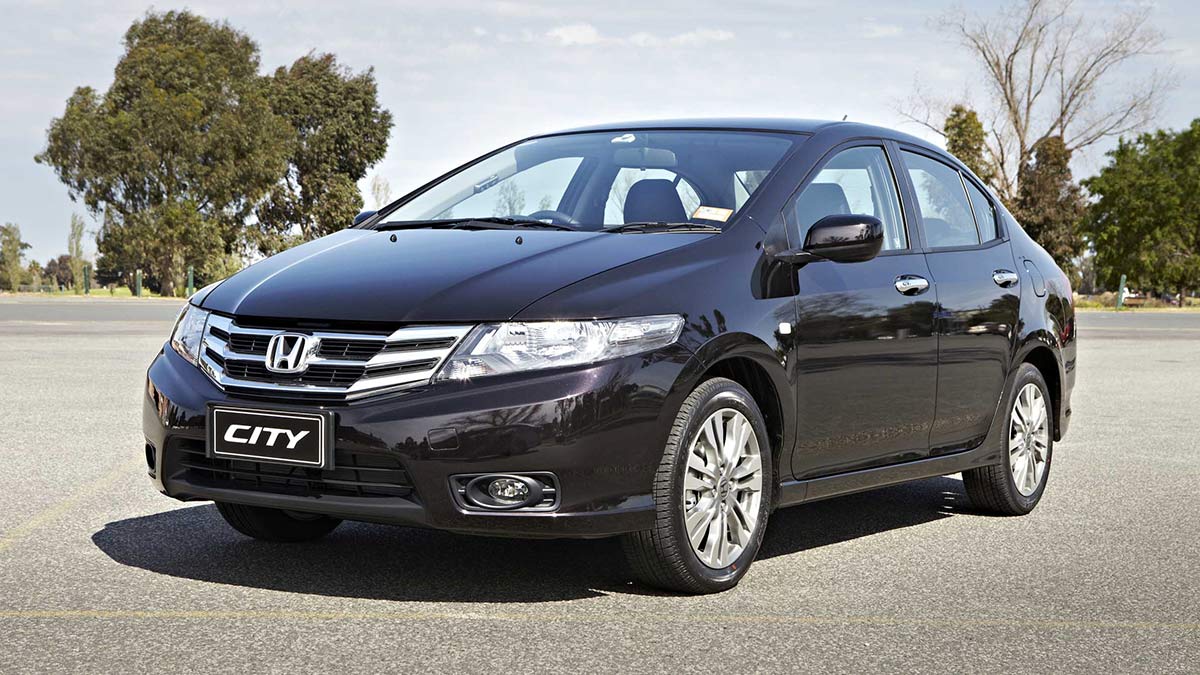 Front side view of a black Honda City parked in a car park