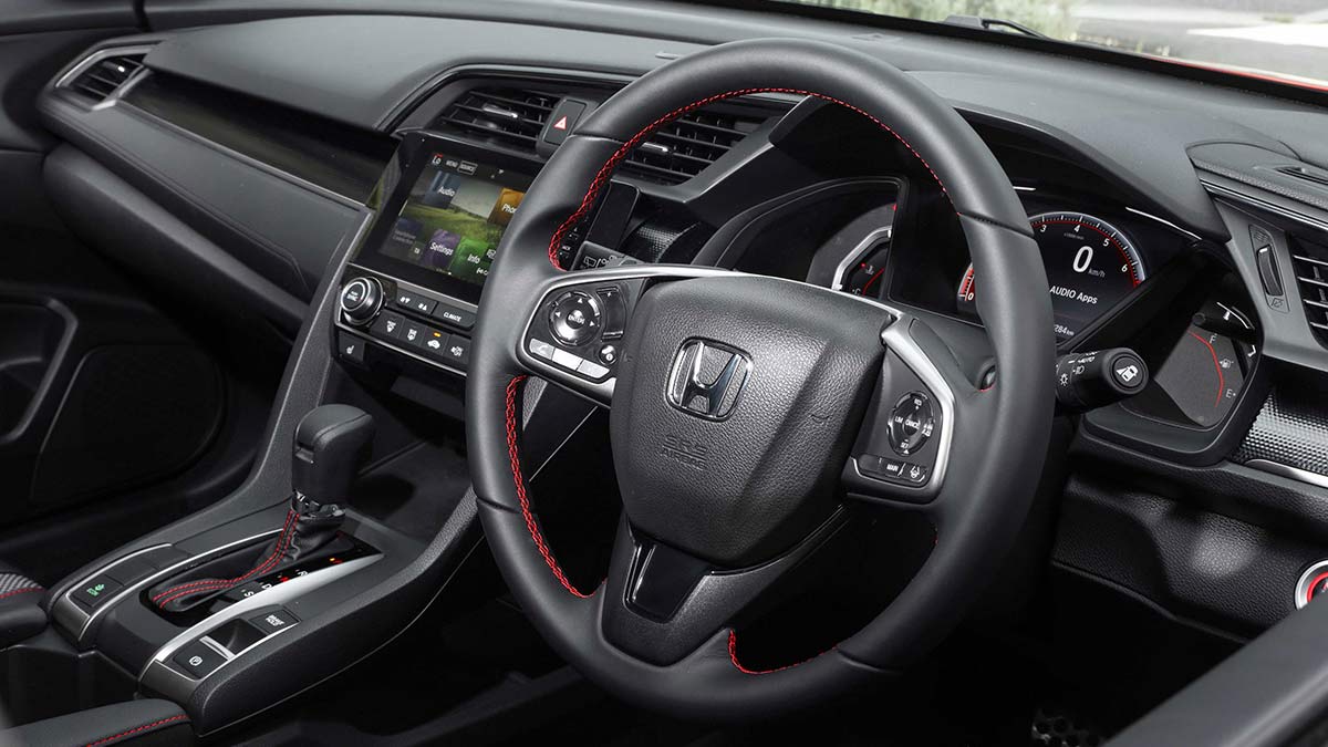 Dark grey interior of the Honda Civic RS hatch 2020 car showing the steering wheel and centre console