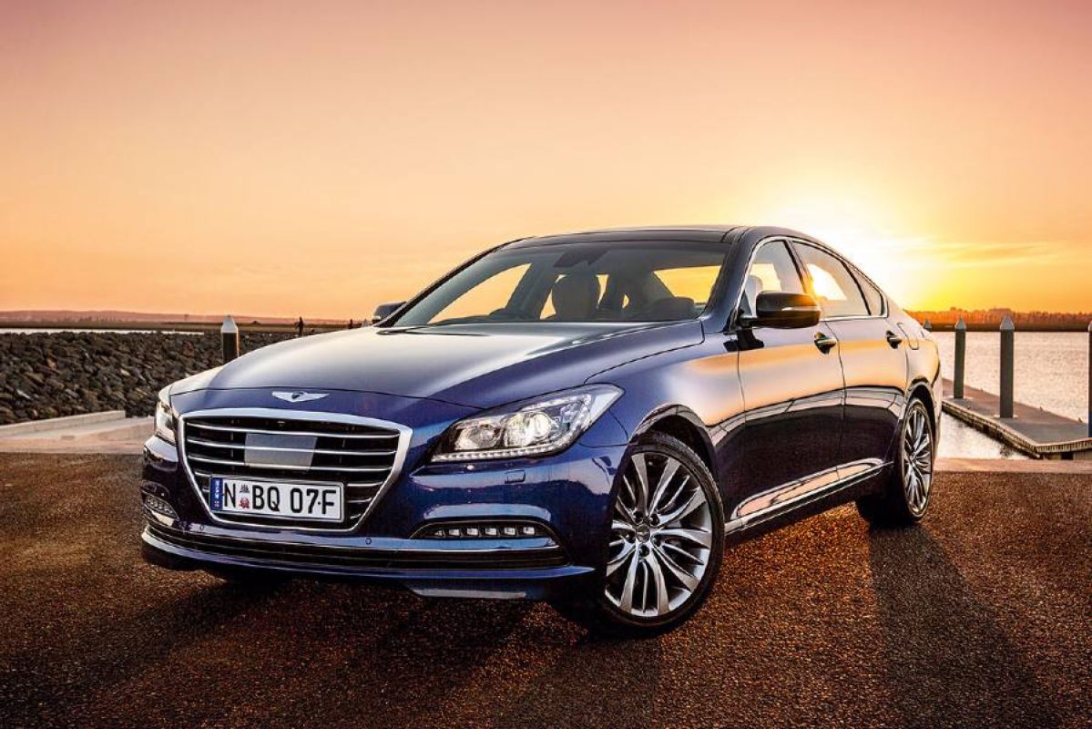 blue hyundai genesis parked near water at sunset