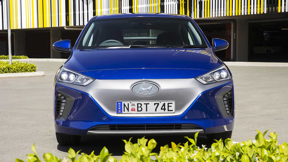 Front view of a blue Hyundai Ioniq 2019 car parked in front of a multi level carpark