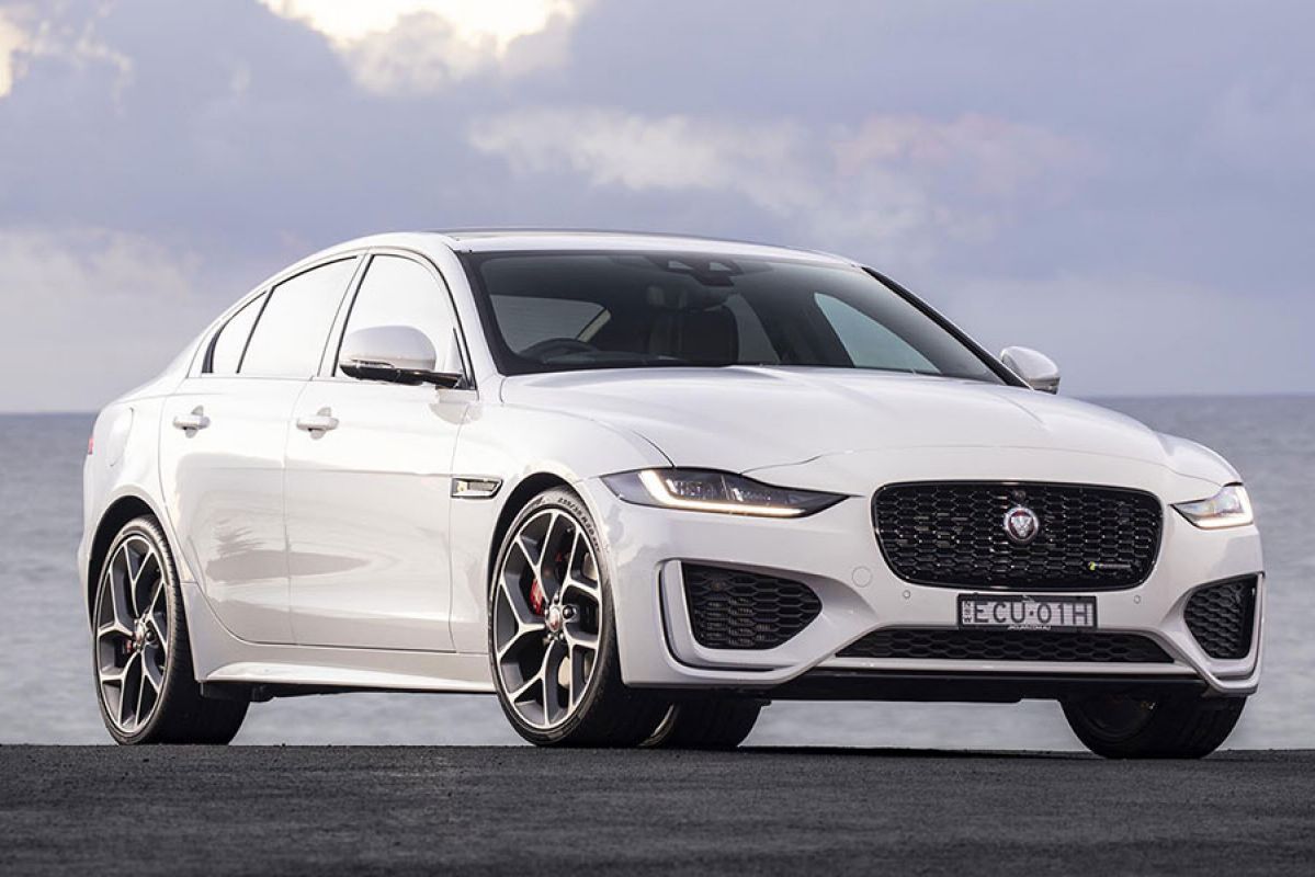 White Jaguar XE R-Dynamic HSE 2020 parked with grey clouds and water in the background