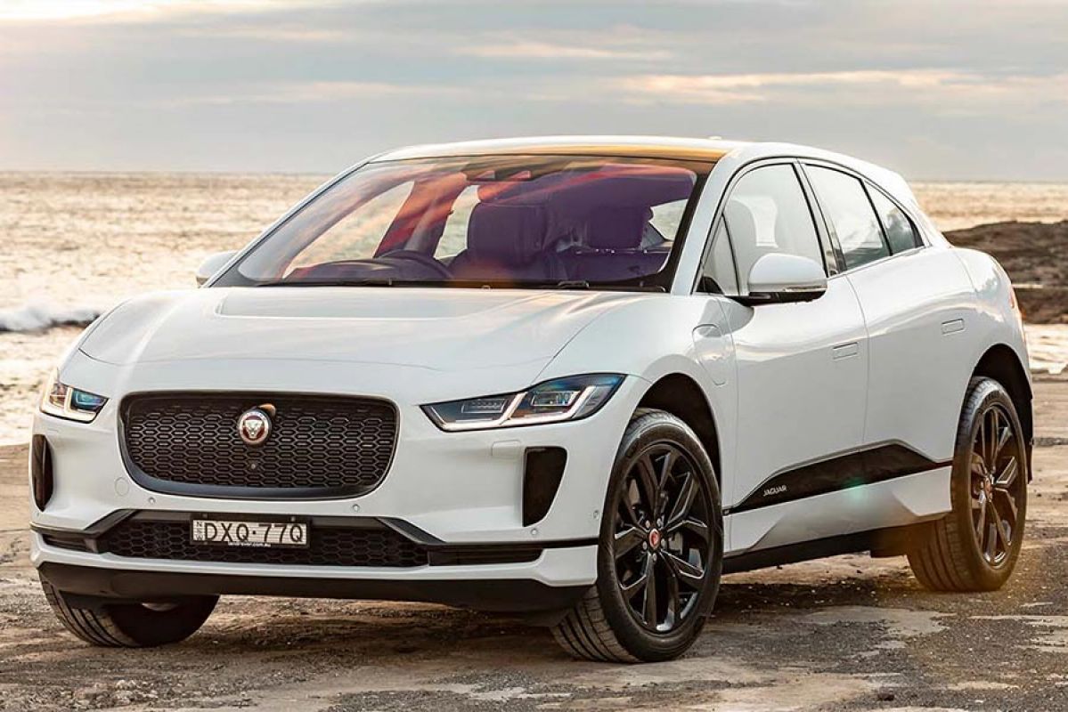 A white Jaguar I-Pace 2019 car parked on a beach