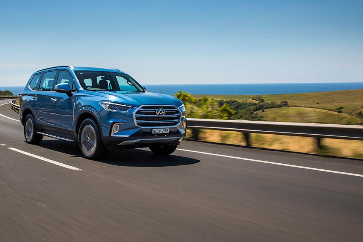 A blue LDV D90 driving on a coastal road