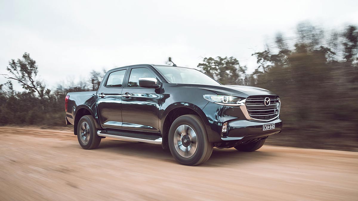 Side view of Mazda BT-50 on dirt terrain