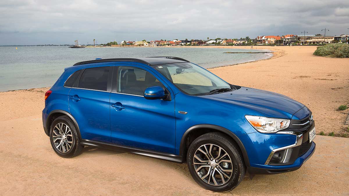 Front side view of a dark blue Mitsubishi ASX XLS parked at the beach