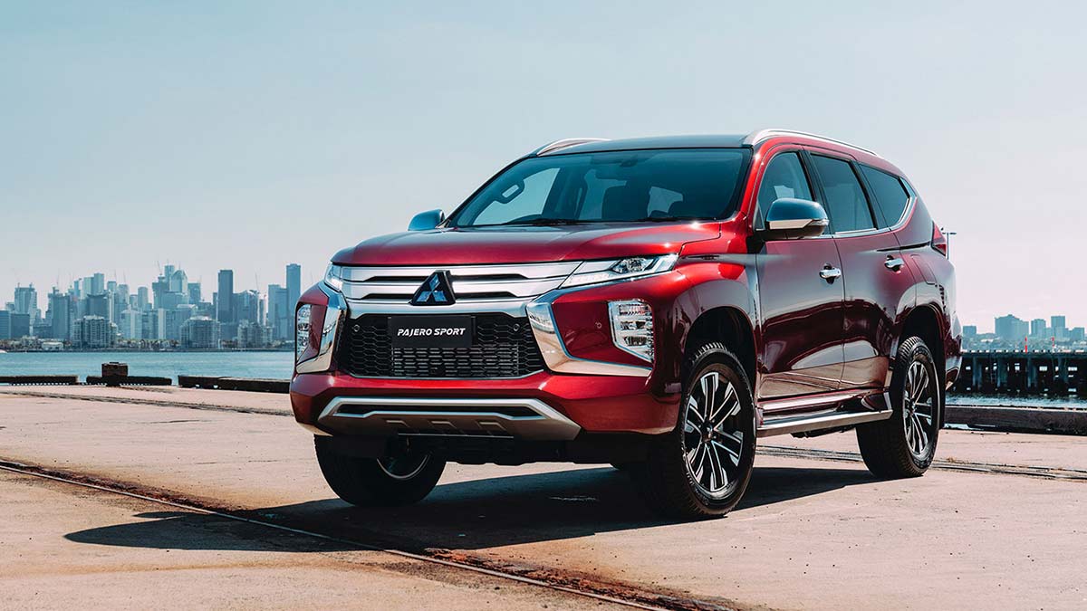 Front angled view of a red Mitsubishi Pajero Sport parked on a dock