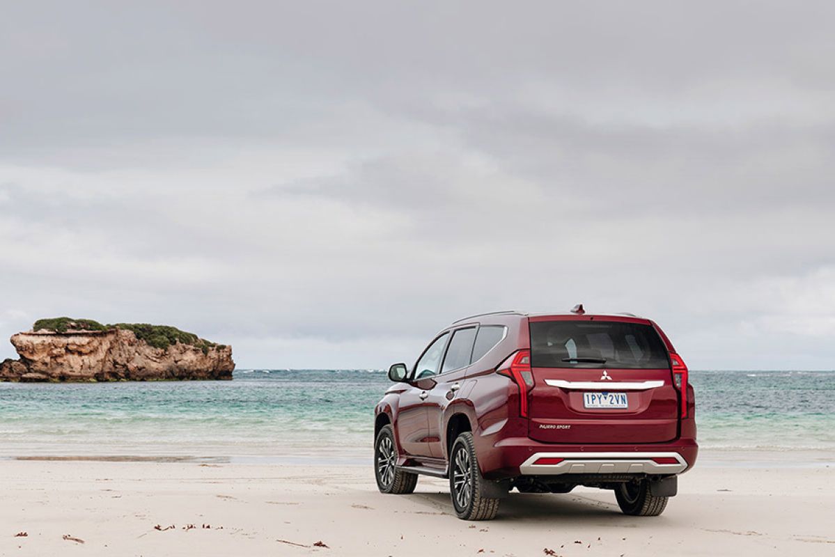 Red Mitsubishi Pajero Sport on the beach