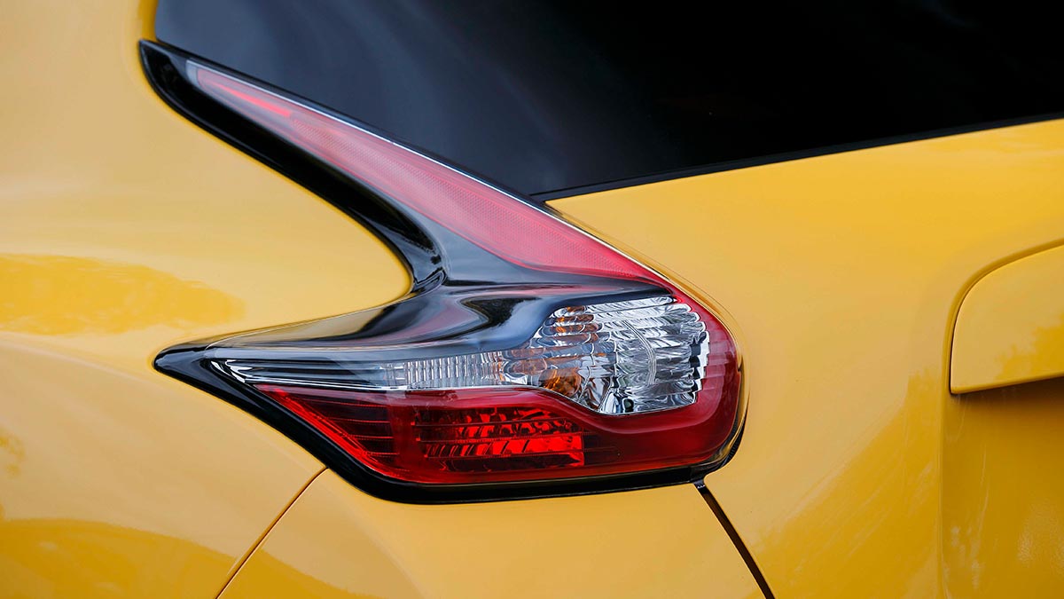 Close up of the tail light on a yellow Nissan Juke