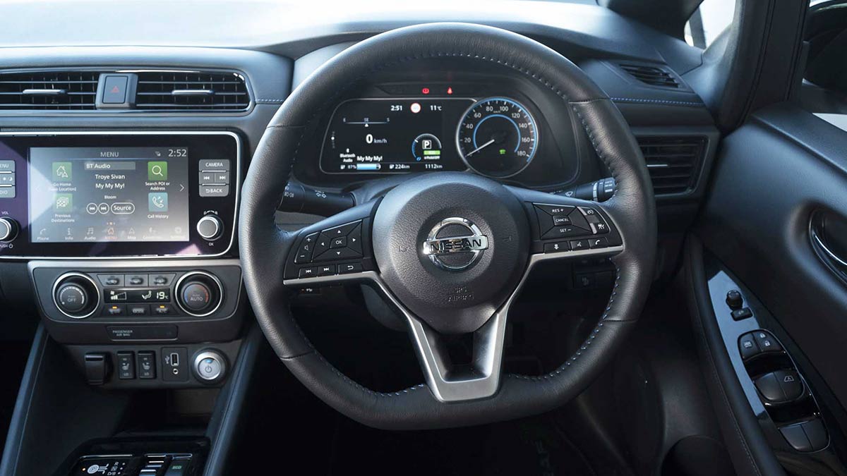 Grey interior of the Nissan Leaf showing the steering wheel and centre console