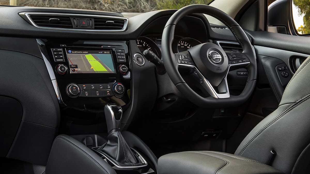 The Nissan Qashqai's interior features: the dash, driver's seat and steering wheel