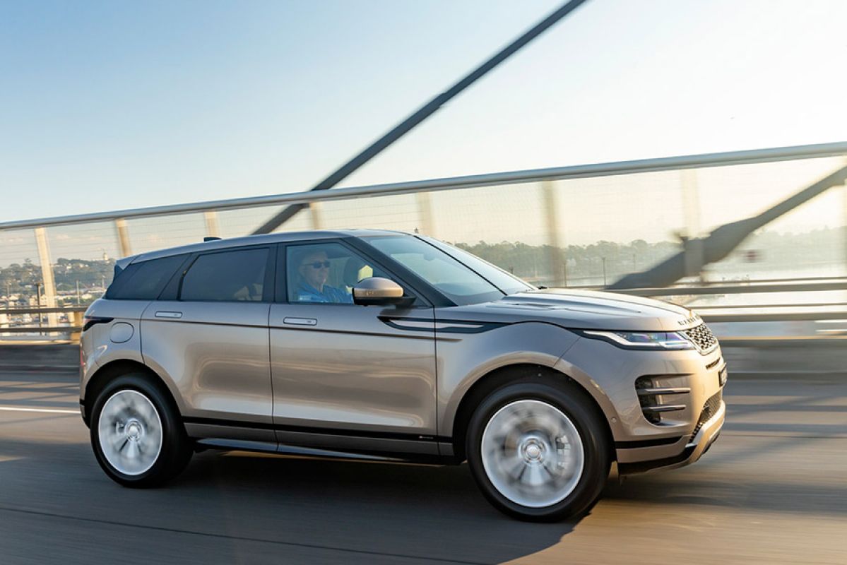 Side view of grey Range Rover Evoque driving across bridge