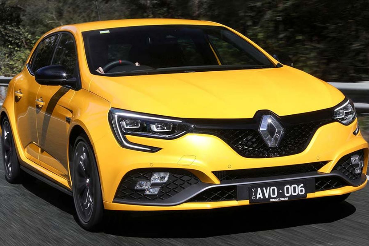 Front view of yellow Renault driving on road