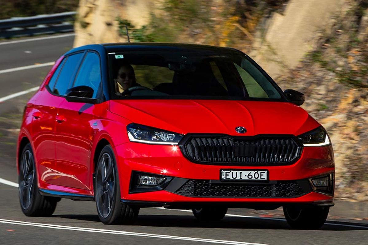 A red Skoda Fabia Monte Carlo powers through a turn.